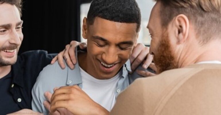 Woman holding a large fern leaf in front of her face.